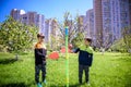 Two friends are playing tetherball swing ball game in summer camping. Two boy brother happy leisure healthy active time outdoors