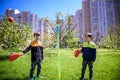 Two friends are playing tetherball swing ball game in summer camping. Two boy brother happy leisure healthy active time outdoors