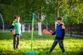 Two friends are playing tetherball swing ball game in summer camping. Two boy brother happy leisure healthy active time outdoors