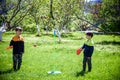 Two friends are playing tetherball swing ball game in summer camping. Two boy brother happy leisure healthy active time outdoors