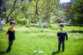 Two friends are playing tetherball swing ball game in summer camping. Two boy brother happy leisure healthy active time outdoors