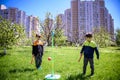 Two friends are playing tetherball swing ball game in summer camping. Two boy brother happy leisure healthy active time outdoors