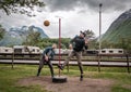 Two friends are playing tetherball