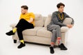 Two Friends Quarreled and Sat on Opposite Sides of the Sofa. Men are in a Quarrel and sit on the Couch at a Distance Royalty Free Stock Photo