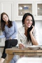 Two friends relaxing in the kitchen Royalty Free Stock Photo