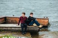 Two friends relaxing on the pier. Royalty Free Stock Photo