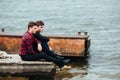 Two friends relaxing on the pier. Royalty Free Stock Photo