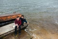 Two friends relaxing on the pier. Royalty Free Stock Photo