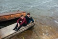 Two friends relaxing on the pier. Royalty Free Stock Photo