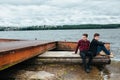 Two friends relaxing on the pier. Royalty Free Stock Photo