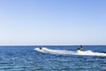 two friends riding water scooter in Ibiza. Blue ocean at sunset. Fun and holidays concept Royalty Free Stock Photo