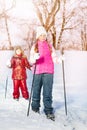 Two friends slide down hill with skies and sticks Royalty Free Stock Photo