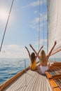 Two friends in swimsuits making peace signs celebrating on a boat cruise. Two women cheerfully celebrating making peace Royalty Free Stock Photo