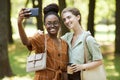 Two Friends Taking Photo in Park Royalty Free Stock Photo