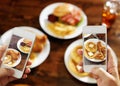 Two friends taking photo of their food with smartphones Royalty Free Stock Photo