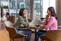 Two friends talking in a cafe and looking involved Royalty Free Stock Photo