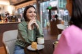 Two friends talking in a cafe and looking involved Royalty Free Stock Photo