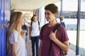 Two friends talking in school corridor at break time