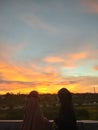 Two Friends telling each other in sunset