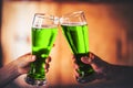 Two friends toasting with glasses of green beer Royalty Free Stock Photo