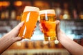 Two friends toasting with glasses of light beer at the pub. Beautiful background of the Oktoberfest. fine grain Royalty Free Stock Photo