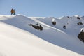 Two friends on the top of the snowy mountain about to drop in