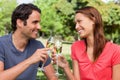 Two friends touching their glasses together in celebration Royalty Free Stock Photo