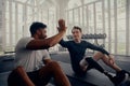 Two friends training in the gym - one with a prosthesis . Two men high fiving in the gym after a good training session Royalty Free Stock Photo