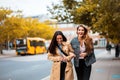 Two friends walking trough city and leafing. Royalty Free Stock Photo