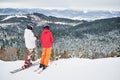 Friends skiers having fun at ski resort in the mountains in winter, skiing and snowboarding Royalty Free Stock Photo