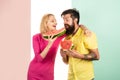 Two friends of woman and man enjoying a watermelon. Friends eating a watermelon slice and laughing together. Royalty Free Stock Photo