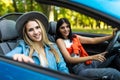 Two friends women on road Trip Driving In Convertible Car Royalty Free Stock Photo