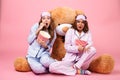 Two frightened pretty girls dressed in pajamas