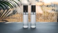 Two Frosted Glass Bottles with Silver Caps on a Dark Surface, Raindrops on Window Background Royalty Free Stock Photo