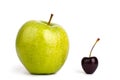 Two fruits one red cherry berry and one big green apple on white background isolated close up macro Royalty Free Stock Photo