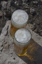 Two full glass glasses with beer on top of the stone outside Royalty Free Stock Photo