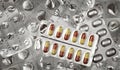 Two full pill blisters on background of empty blisters Royalty Free Stock Photo