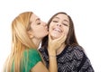 Two funny affectionate teenage friends laughing and kissing