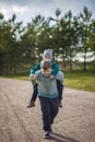 Two funny boys-brother and friend, walking together in the spring park, running, jumping and enjoying Royalty Free Stock Photo