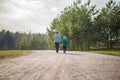 Two funny boys-brother and friend, walking together in the spring park, running, jumping and enjoying Royalty Free Stock Photo