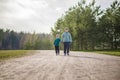 Two funny boys-brother and friend, walking together in the spring park, running, jumping and enjoying Royalty Free Stock Photo