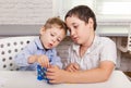 Two funny brothers are playing a board game together on desk at home Royalty Free Stock Photo