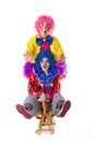 Two funny colorful clown fooling around on a white background