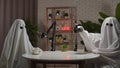 Two funny ghosts record a podcast in a studio Royalty Free Stock Photo