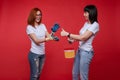 Two funny girlfriend laughing doing apartment repair wearing work gloves