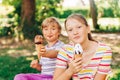 Two funny kids eating ice cream in summer park Royalty Free Stock Photo