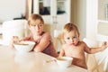 Two funny kids, little boy and girl eating pasta lunch