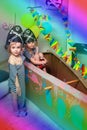 Two funny kids play in pirate costumes in a cardboard sea ship at home