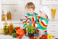 Two funny little boys cooking italian soup and meal with fresh v Royalty Free Stock Photo