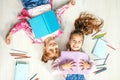 Two funny little girls with books. Flat lay. The concept of children